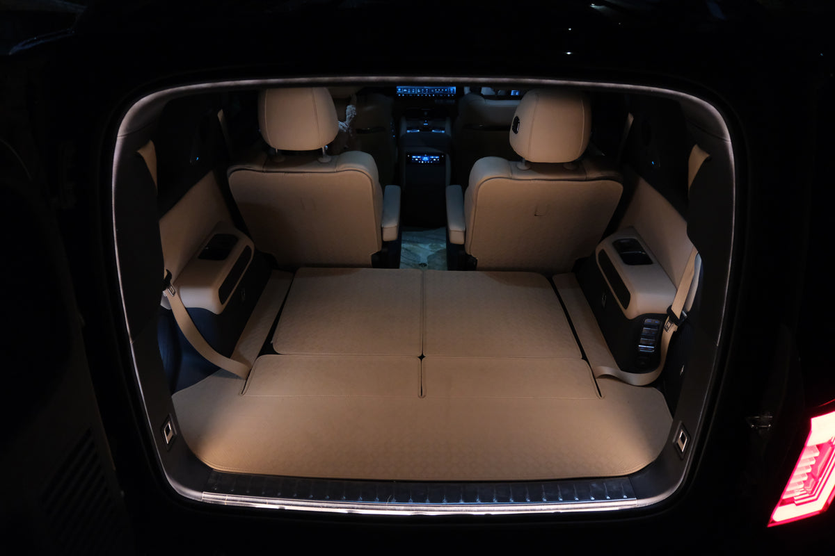 Rear cargo view of the Denza B8 with BAOLAB hidden perimeter boot light on, showing even illumination across the boot area at night.