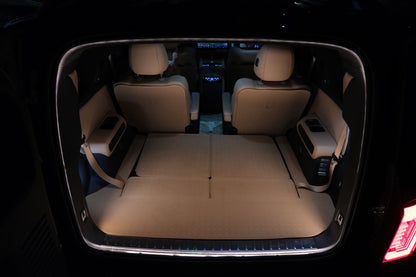Rear cargo view of the Denza B8 with BAOLAB hidden perimeter boot light on, showing even illumination across the boot area at night.