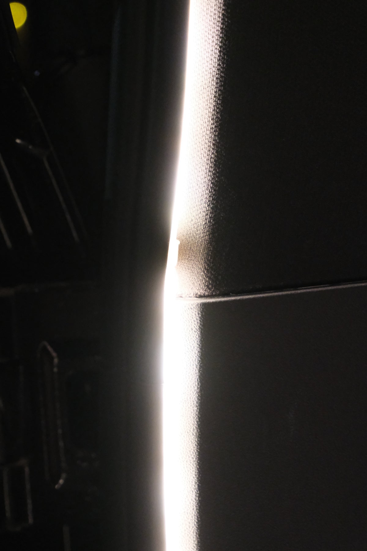 Close-up detail of the BAOLAB hidden perimeter boot light installed along the Denza B8 boot trim, showing the smooth continuous light output.