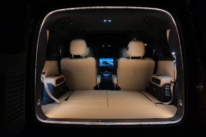 Denza B8 boot opening illuminated by BAOLAB hidden perimeter boot light, showing a continuous soft white glow around the cargo opening at night.